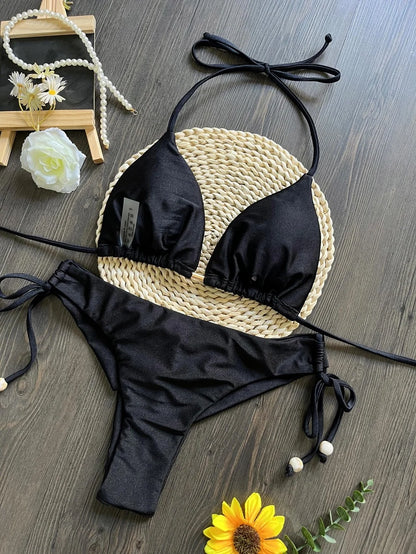 Two-piece micro bikini set by The Clothing Company Sydney featuring triangle swimwear in vibrant colors on a beach background.