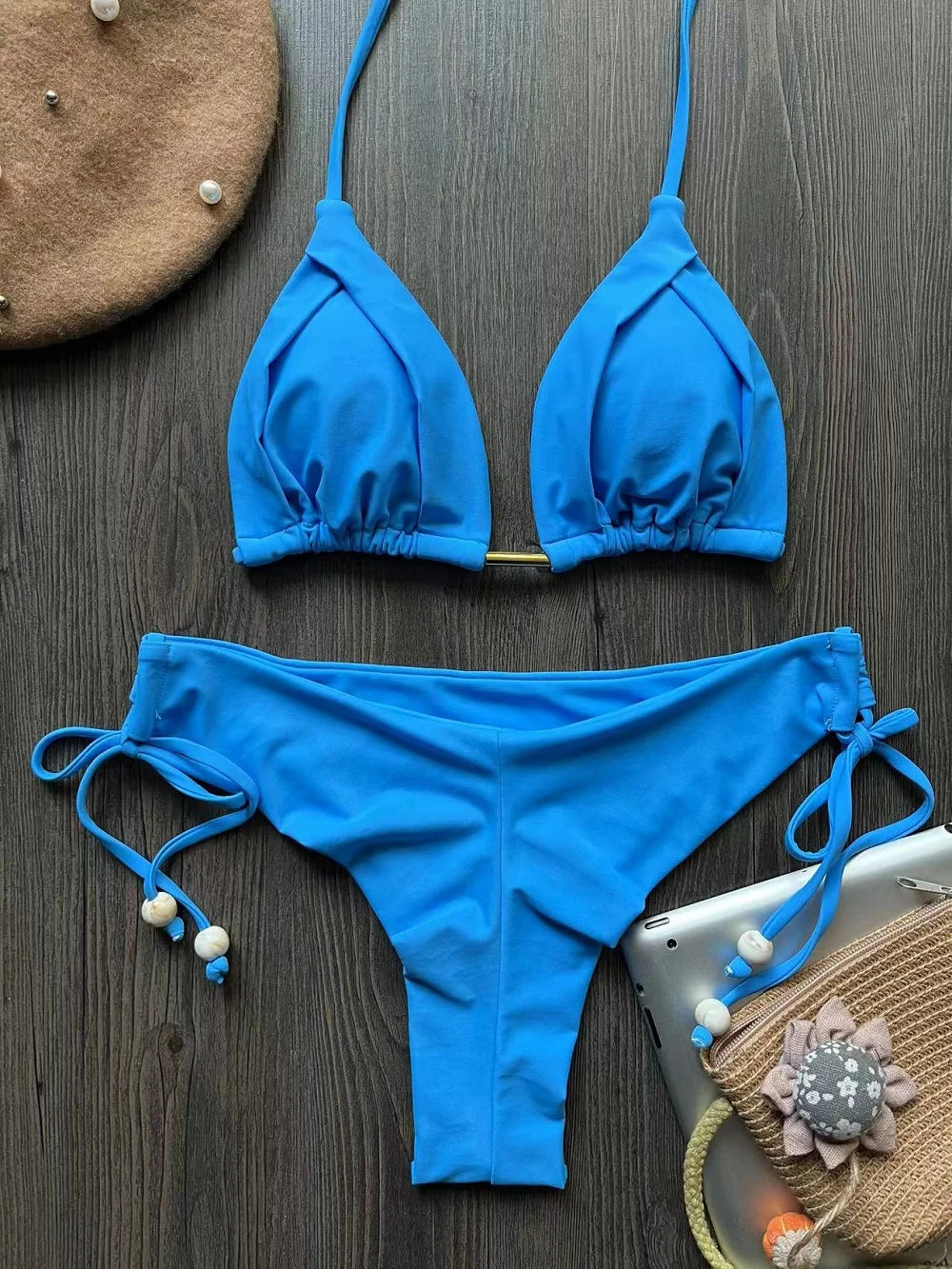 Two-piece pink micro bikini set with triangle tops and matching bottoms, perfect for beachwear and swimming.