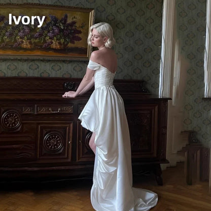 Satin off-shoulder bridal gown with ruched bodice, lace-up back, short front and long train wedding dress