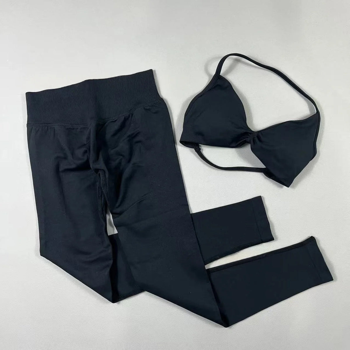 Women's seamless yoga set with halter neck sports bra and high-waisted lifting leggings by The Clothing Company Sydney