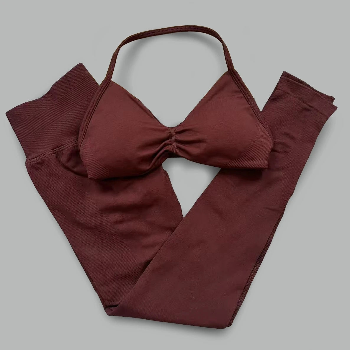 Women's seamless yoga set with halter neck sports bra and high-waisted lifting leggings in two-piece fitness outfit