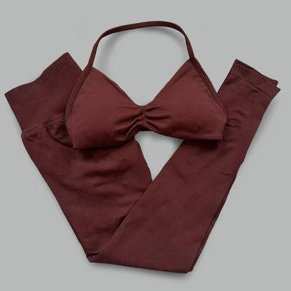 Women's seamless yoga set with halter neck sports bra and high-waisted lifting leggings in two-piece fitness outfit