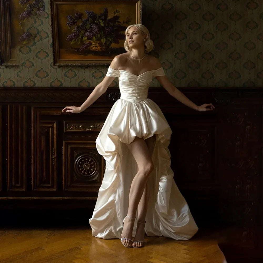 Satin off-shoulder bridal gown with ruched bodice, lace-up back, short front and long train by The Clothing Company Sydney